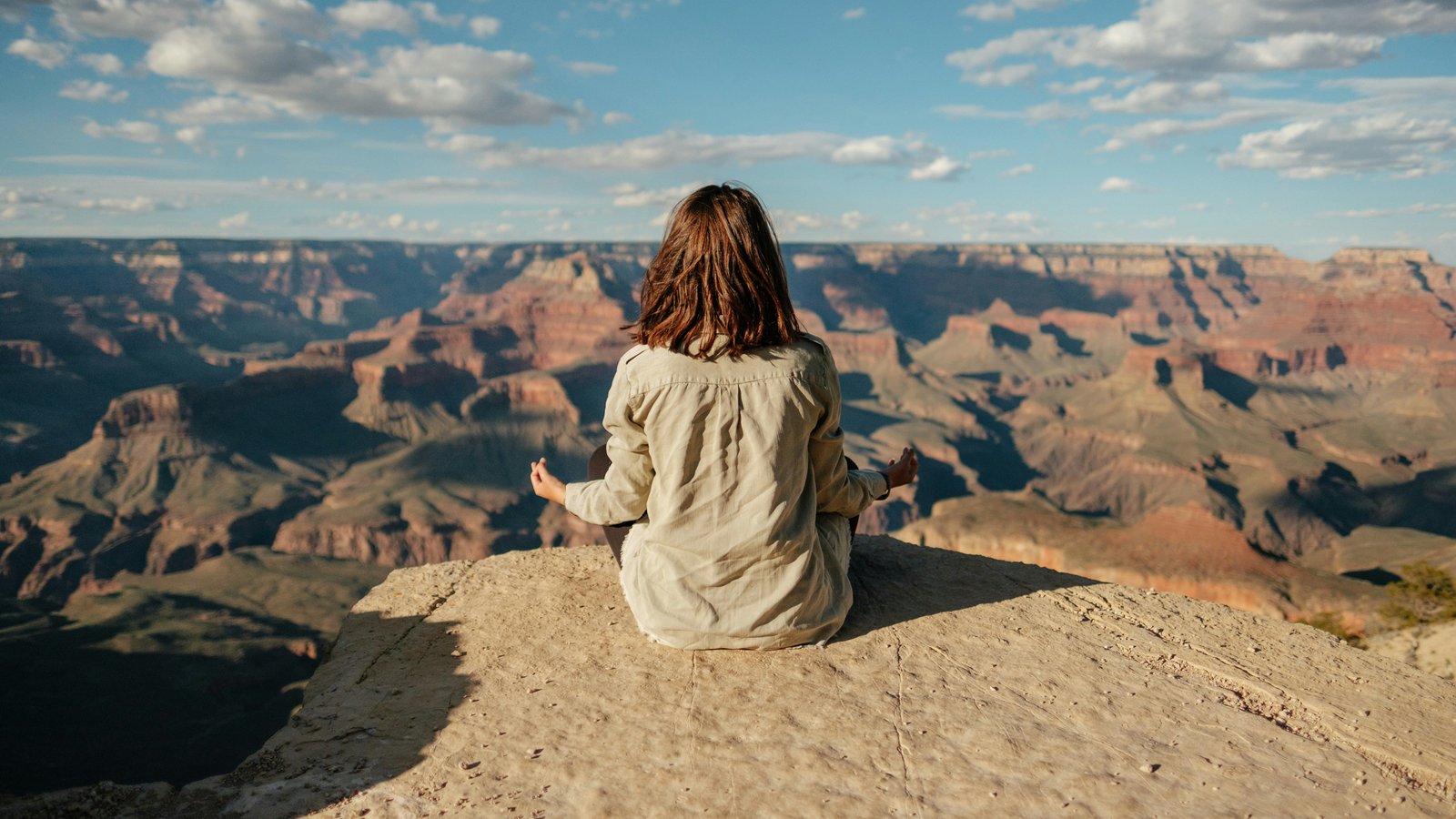 Woman sitting alone on a hillside